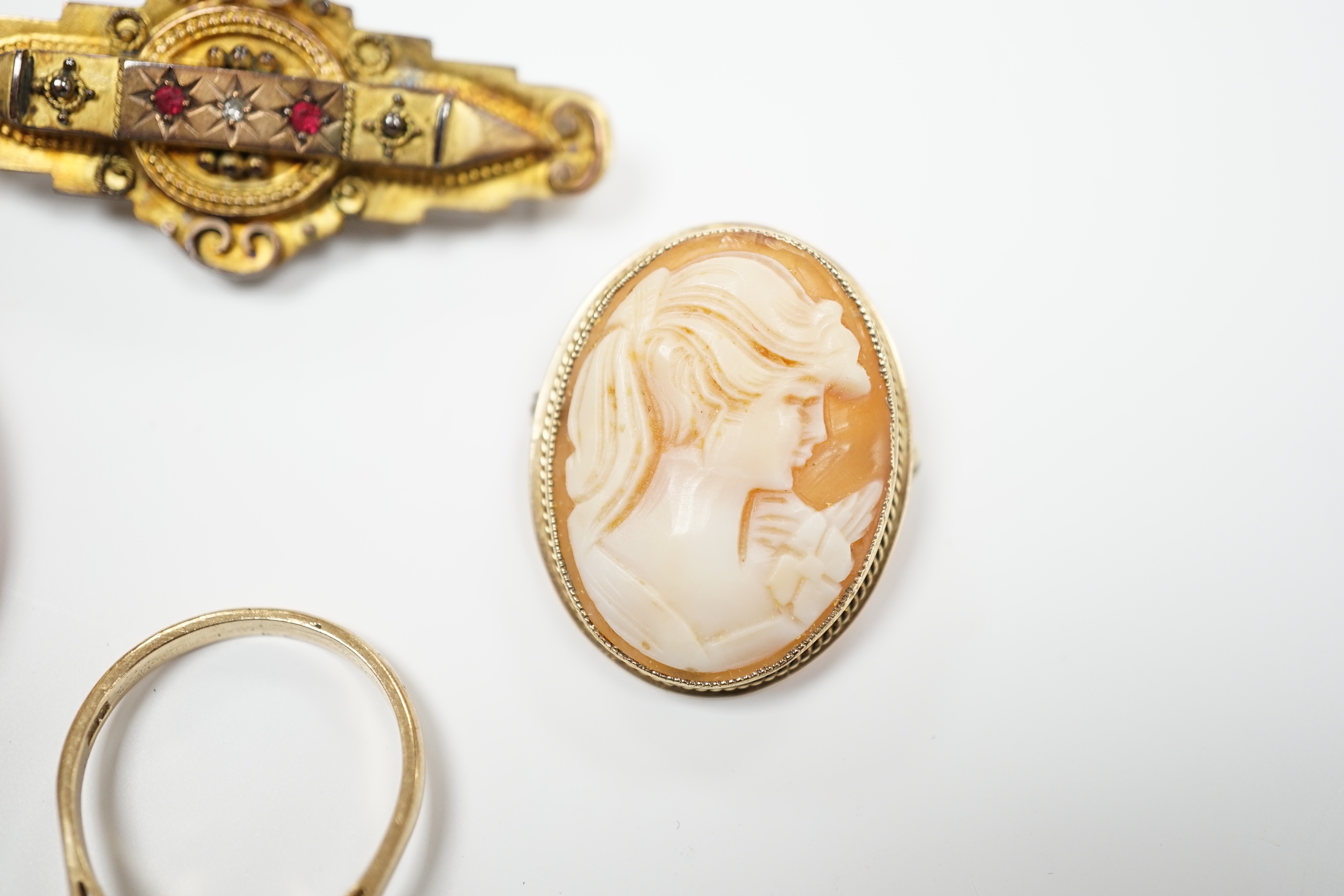 Two 9ct mounted oval cameo shell brooches, largest 38mm, a 9ct and gem set ring and a 9ct gold and gem set bar brooch.